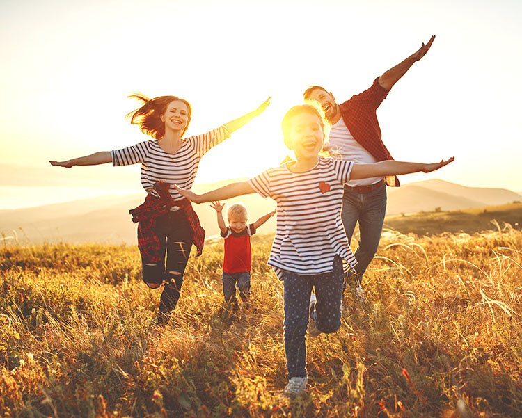 family pretending to fly with arms outstretched