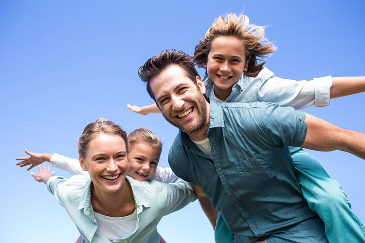 family pretending to fly with arms outstretched