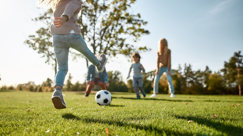 children playing soccer in the park